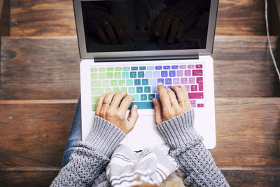 Hands of woman using laptop