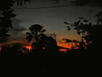 Low angle view of silhouette trees against sky at sunset