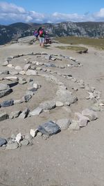 Hikers with stones on mountain