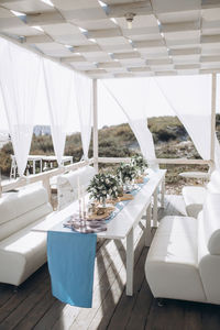 Restaurant hall on the sea coast, decorated with paper lamps and white fabrics