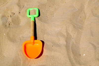 High angle view of shovel on sand at beach