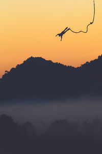 Silhouette of one person bungee jumping