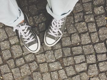 Low section of person standing on footpath