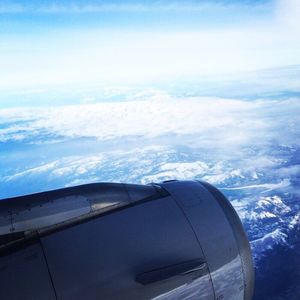 Cropped image of airplane flying in sky