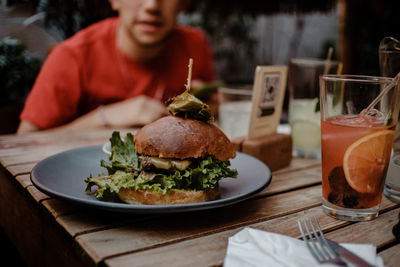 Midsection of person sitting at restaurant