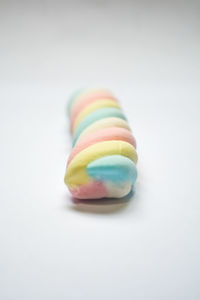 Close-up of multi colored candies against white background