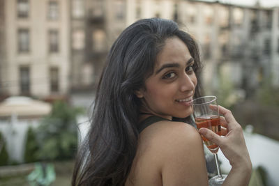 Young woman with a glass of wine at a party