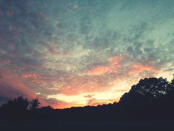 Silhouette trees against sky during sunset