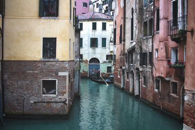 Canal amidst old buildings in city