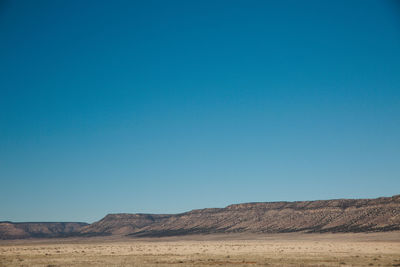 View of desert against blue sky