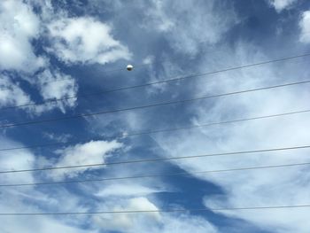 Low angle view of birds flying against sky