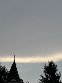 High section of silhouette building against sky during sunset