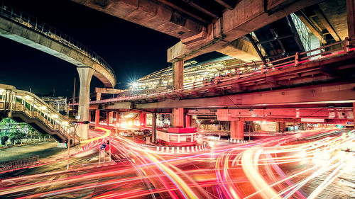 Light trails on bridge in city at night