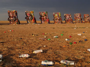 Panoramic view of beach umbrellas on field against sky