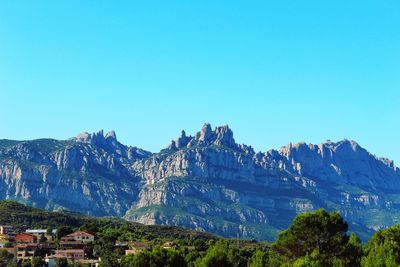 Panoramic view of mountain range against blue sky