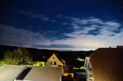 Buildings in city against sky at night