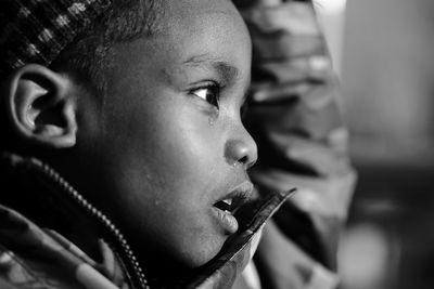 Close-up of boy looking away and crying