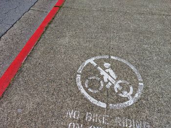 High angle view of bicycle sign on road. not allowed. 