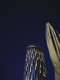 Low angle view of illuminated building against sky at night