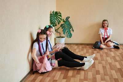 High school girl is resting while sitting on the floor. anime style