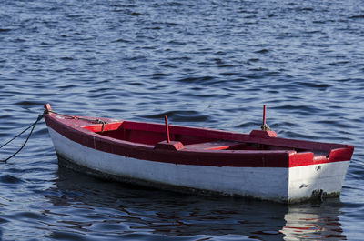 Red and white fishing boat anchored at ribeira beach. salvador bahia brazil.