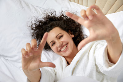 Portrait of woman lying down on bed