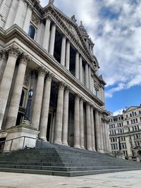 Low angle view of building against cloudy sky