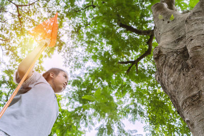 Along with a bug catcher she looked at the big tree. pure natural energy concept