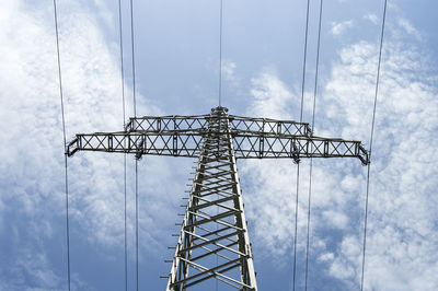 Low angle view of electricity pylon against sky