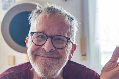 Portrait of man wearing eyeglasses at home