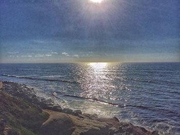 Close-up of sea against sky at sunset