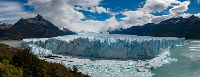 Panoramic view of frozen lake against sky