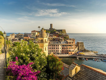 Scenic view of sea by buildings against sky