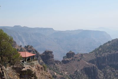 Panoramic shot of building and mountains against sky