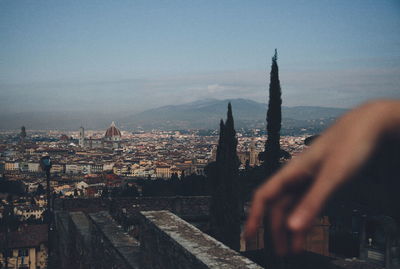 Panoramic view of buildings in town against sky