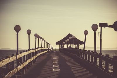 Pier over sea against clear sky