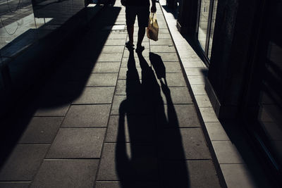 Low section of people walking on footpath