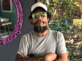 Portrait of young man wearing sunglasses standing outdoors