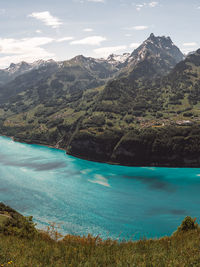 Scenic view of lake and mountains against sky