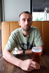 Portrait of mid adult man sitting at table