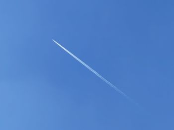 Low angle view of vapor trails in sky