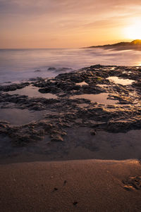 Scenic view of sea against sky at sunset