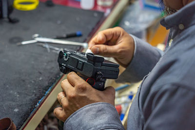 Midsection of man working in workshop