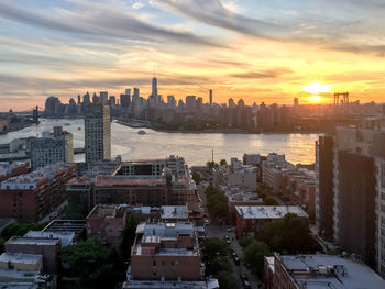 High angle view of buildings in city against sky during sunset