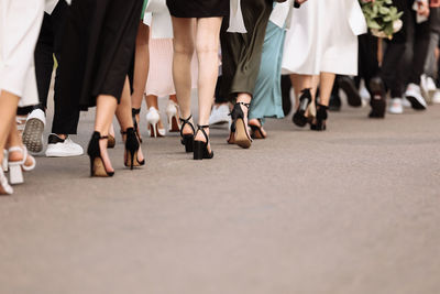 Low section of people walking on street