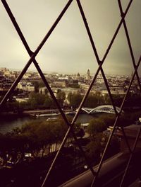 Bridge over river against cloudy sky