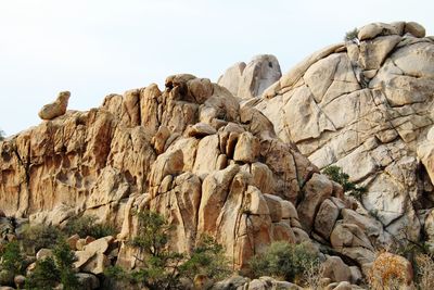 Low angle view of rock formation against clear sky