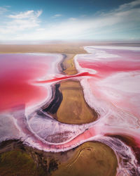 Aerial view of a partially dried up salt lake divided by an oblique sunny day. natural extraction 