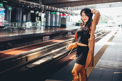 Full length of woman standing against blurred background