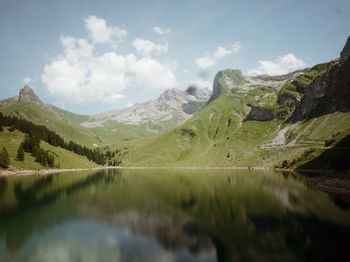 Scenic view of lake and mountains against sky